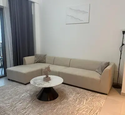 a living room with a couch and a table at Enjoy Sunset at Creek Beach in Dubai