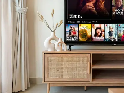 a flat screen tv sitting on top of a wooden entertainment center at Cozy Home w Spectacular Water View in Dubai