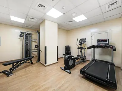 a gym with two treadmills and two exercise bikes at Cozy Home w Spectacular Water View in Dubai