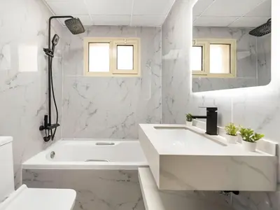a white bathroom with a tub and a sink at Cozy Home w Spectacular Water View in Dubai