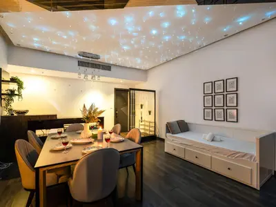 a living room with a dining table and a couch at Luxurious 2BR Apt with Marina View & Private Jacuzzi in Dubai