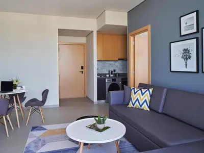 a living room with a couch and a table at Private Apartment in Novotel JVT Comfort for 4 Guests in Dubai