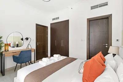 a bedroom with a bed with a desk and a chair at Silkhaus Dubai Marina 1BR in Bay Central West Tower in Dubai