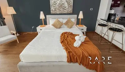 a bedroom with a large bed with a blanket on it at Rare Holiday Homes - Mediterranean Cluster - Near Ibn Battuta Mall - Discovery Garden - Building# Med 38 - RG04 in Dubai