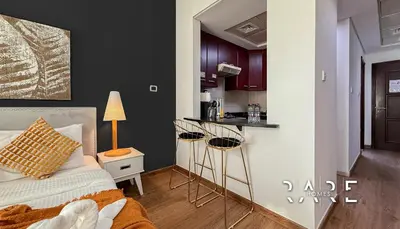 a bedroom with a bed and a small kitchen at Rare Holiday Homes - Mediterranean Cluster - Near Ibn Battuta Mall - Discovery Garden - Building# Med 38 - RG04 in Dubai