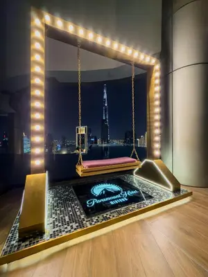 a room with a bed with a view of a city at Sky Suite 1 Bedroom Apartment with Infinity Rooftop Pool and Dubais Ultimate Skyline View at Paramount Midtown in Dubai