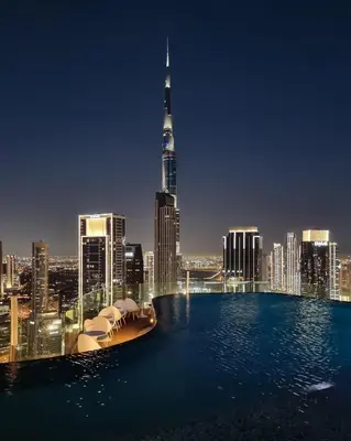 a view of the dubai skyline at night at Sky Suite 1 Bedroom Apartment with Infinity Rooftop Pool and Dubais Ultimate Skyline View at Paramount Midtown in Dubai