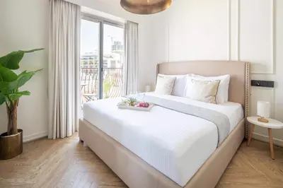 a bedroom with a large white bed with a window at Frank Porter - Rokane G22 in Dubai