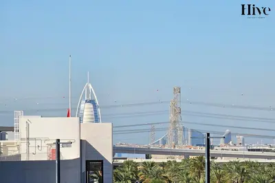 a view of a city with a bridge and buildings at Cosy 1 bed Apt in Dubai Hills in Dubai