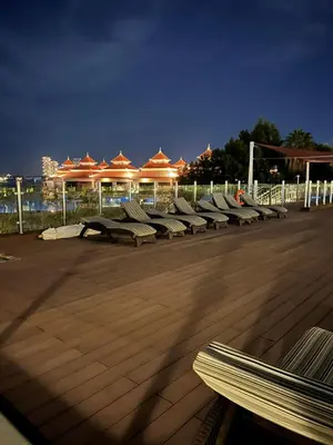 a row of benches sitting on a deck at night at Cozy Home with Beach Access in Palm Jumeirah in Dubai