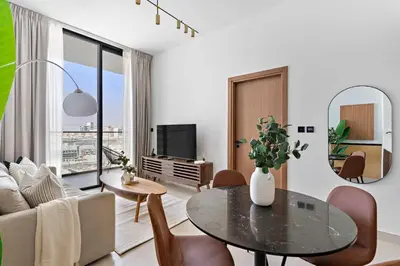 a living room with a table and a couch at Silkhaus Classic 1BDR Apartment in Binghatti House in Dubai