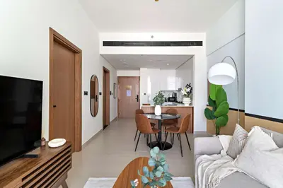 a living room with a couch and a table at Silkhaus Classic 1BDR Apartment in Binghatti House in Dubai