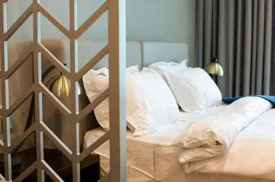 a bedroom with a bed with white pillows at Luxury Studio Apartment in Downtown Dubai in Dubai