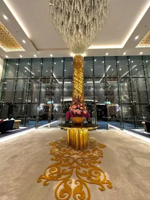 a large lobby with a large chandelier and a vase with flowers at Luxury Studio Apartment in Downtown Dubai in Dubai
