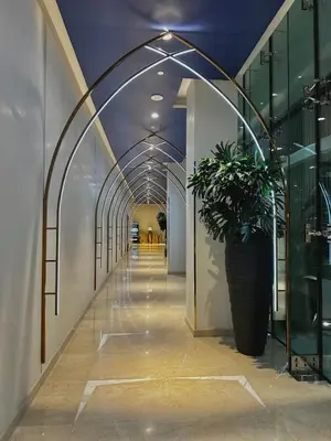 a hallway in a building with a potted plant at Luxury Studio Apartment in Downtown Dubai in Dubai