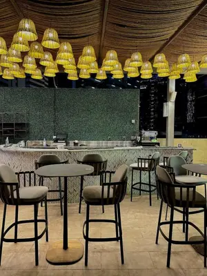 a restaurant with tables and chairs and lights at Luxury Studio Apartment in Downtown Dubai in Dubai