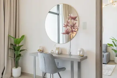 a dressing table with a mirror and a chair at Luxury Stay JVC Modern 1BHK Pool & Gym Access in Dubai