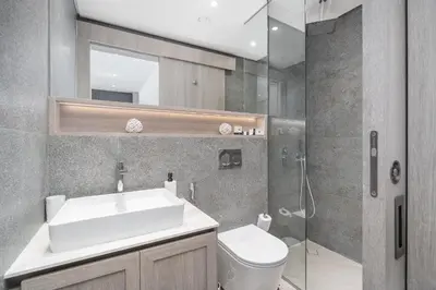 a bathroom with a sink and a toilet and a shower at Luxury Stay JVC Modern 1BHK Pool & Gym Access in Dubai