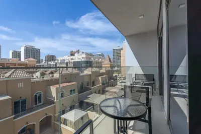 a balcony with a table and a view of the city at Luxury Stay JVC Modern 1BHK Pool & Gym Access in Dubai
