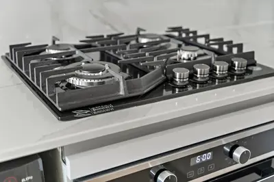 a stove top oven with a black stove top at FIRST CLASS 1BR Cozy Urban Getaway in Dubai