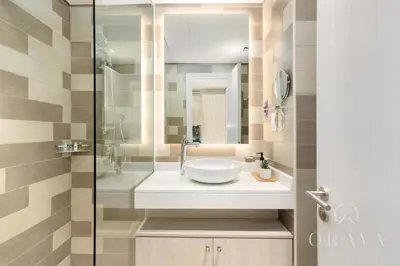 a bathroom with a sink and a glass shower at Luxurious Studio In Seven Palm - Direct Beach Access in Dubai