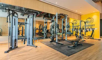 a gym with several tread machines in a room at Luxurious Studio In Seven Palm - Direct Beach Access in Dubai