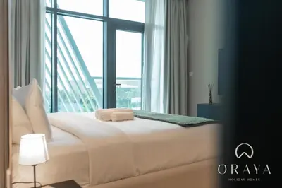 a white bed in a room with a large window at Luxurious Studio In Seven Palm - Direct Beach Access in Dubai