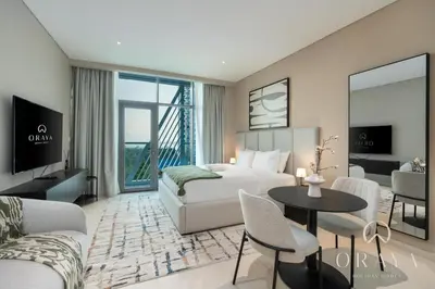 a hotel room with a bed and a table and chairs at Luxurious Studio In Seven Palm - Direct Beach Access in Dubai
