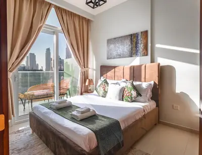 a bedroom with a bed with a large window at Full burj khalifa view 1bhk app in Dubai