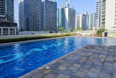 a swimming pool in a city with tall buildings at Full burj khalifa view 1bhk app in Dubai