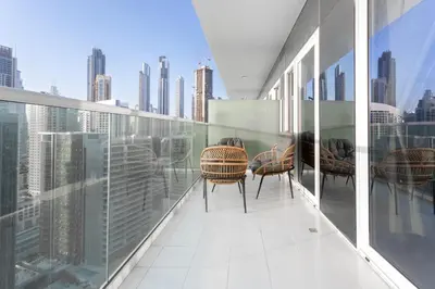 a balcony with chairs and a view of the city at Full burj khalifa view 1bhk app in Dubai