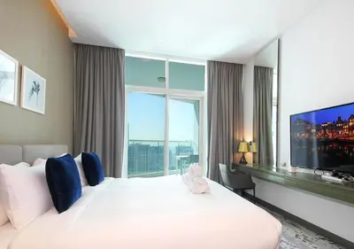 a hotel room with a large bed and a large window at Waterfront Studio with Balcony Near Dubai Mall in Dubai