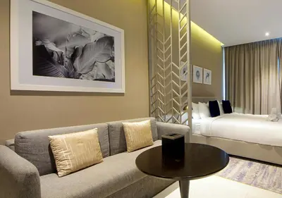 a living room with a couch and a bed at Waterfront Studio with Balcony Near Dubai Mall in Dubai
