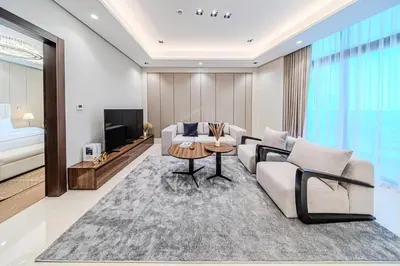 a living room with a couch and a table at Spacious & Elegant 1BD, for 2 in Nobles tower in Dubai