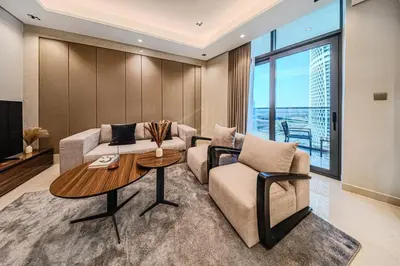 a living room with a couch and a table at Spacious & Elegant 1BD, for 2 in Nobles tower in Dubai
