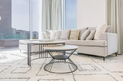 a living room with a couch and a table at Charming 1 Bedroom Apt in MBR - Near Downtown Dubai in Dubai