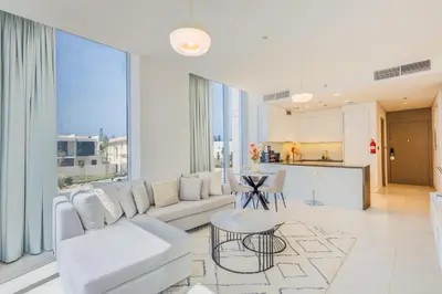 a living room with a white couch and a table at Charming 1 Bedroom Apt in MBR - Near Downtown Dubai in Dubai