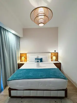 a bedroom with a large bed with two night stands at Holiday Homes by DO - Dubai Marina in Dubai