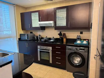 a kitchen with a washing machine and a dishwasher at Holiday Homes by DO - Dubai Marina in Dubai