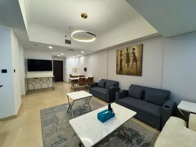 a living room with a couch and a table at Holiday Homes by DO - Dubai Marina in Dubai