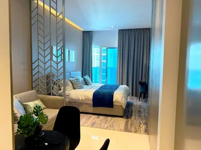 a bedroom with a bed and a living room at Bellaviu Holiday Homes- Escape the Buzz-Your Quiet Spot in DAMAC Prive in Dubai