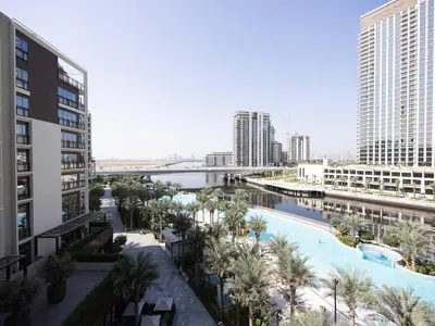 arial view of a resort with a pool and buildings at Sunset Creek Harbour, Dubai in Dubai