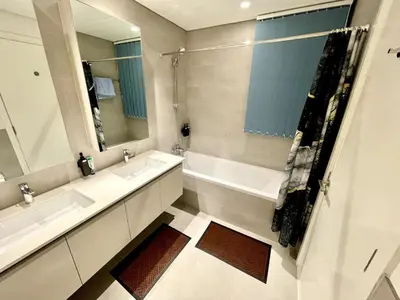 a bathroom with two sinks and a large mirror at Sunset Creek Harbour, Dubai in Dubai