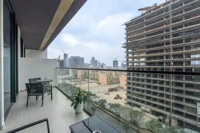 a balcony with a view of a large building at Stylish 1BHK by CzechIn Pool & Gym Prime JVC in Dubai