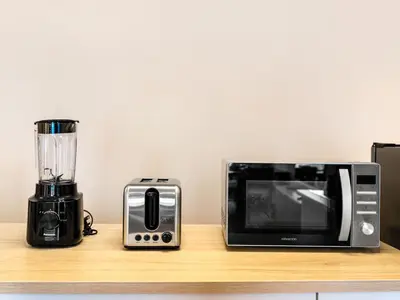 a microwave and a blender sitting on a counter at Luxury 4BR - Full Marina View - High Floor Bliss in Dubai