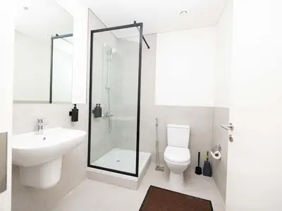 a bathroom with a toilet and a sink and a shower at Beachfront Family Entire Unit in Dubai Ras Al-Khor in Dubai