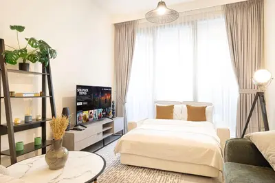 a living room with a bed and a tv at FORTE Tower 2 - One-Bedroom Apartment in DOWNTOWN Dubai, near Burj Khalifa & Dubai Fountains - Apartment in Forte Tower 2 in Dubai