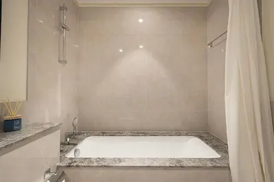 a bath tub in a bathroom with a shower at FORTE Tower 2 - One-Bedroom Apartment in DOWNTOWN Dubai, near Burj Khalifa & Dubai Fountains - Apartment in Forte Tower 2 in Dubai