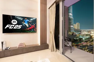 a living room with a tv on the wall at NEW YEARS Luxury Burj Khalifa and Fountain Views in Dubai