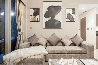 a living room with a couch and a hat on the wall at NEW YEARS Luxury Burj Khalifa and Fountain Views in Dubai
